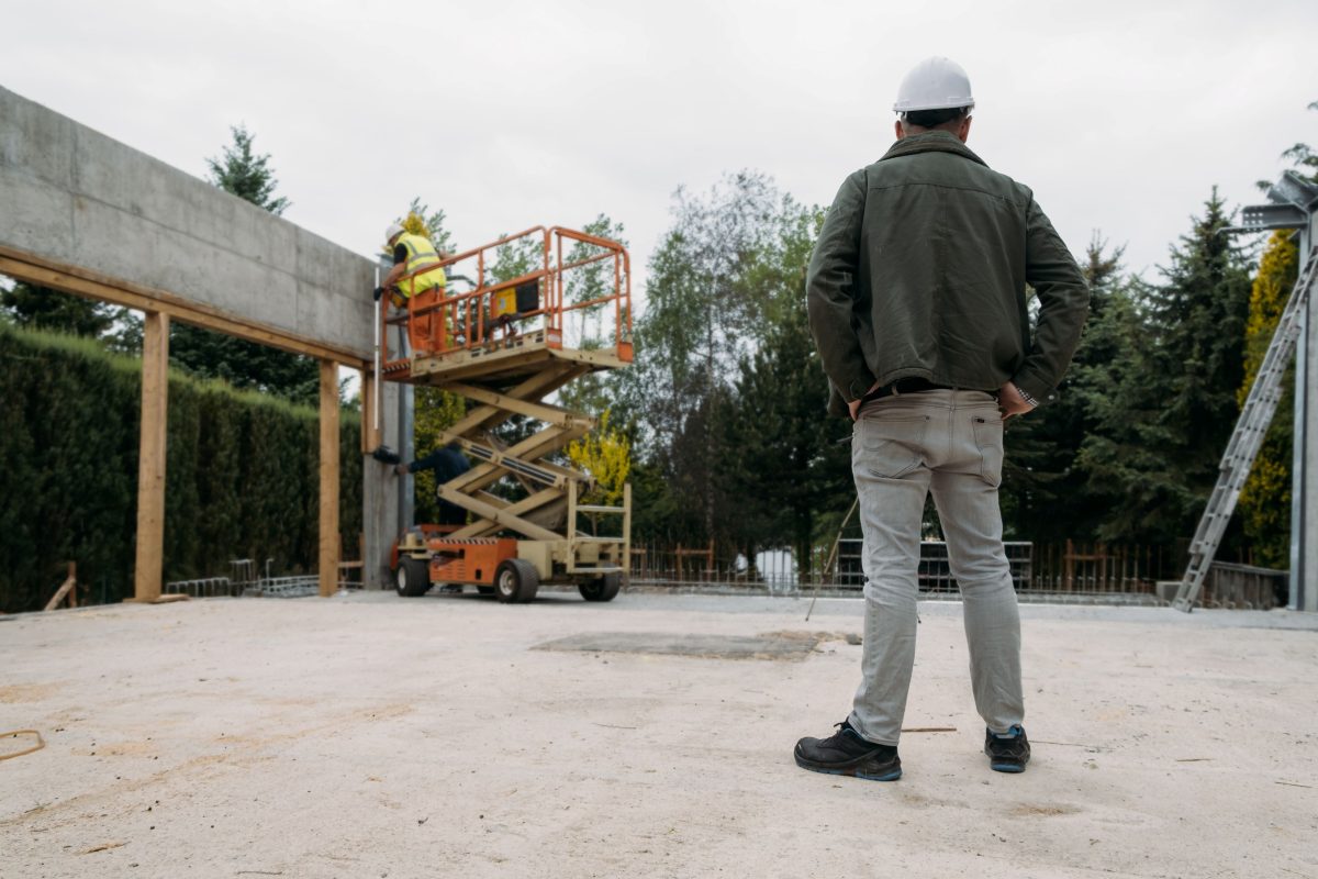 man watching operator on scissor lift