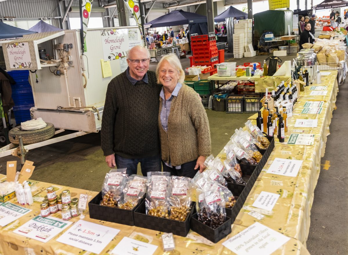 man and woman at a market stall