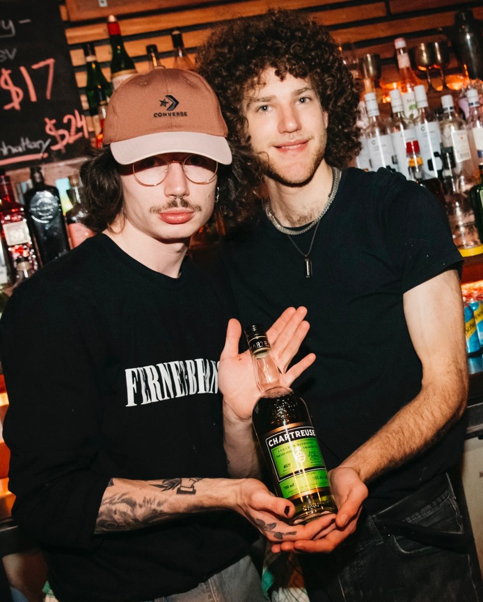 two men holding a bottle