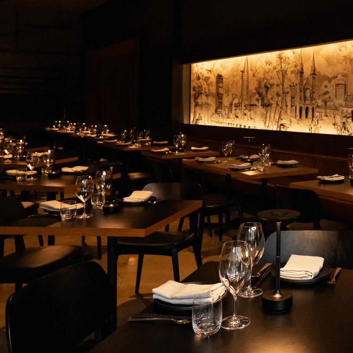 A dining room with long mural.