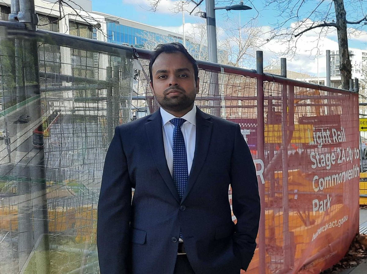 man in suit near construction works