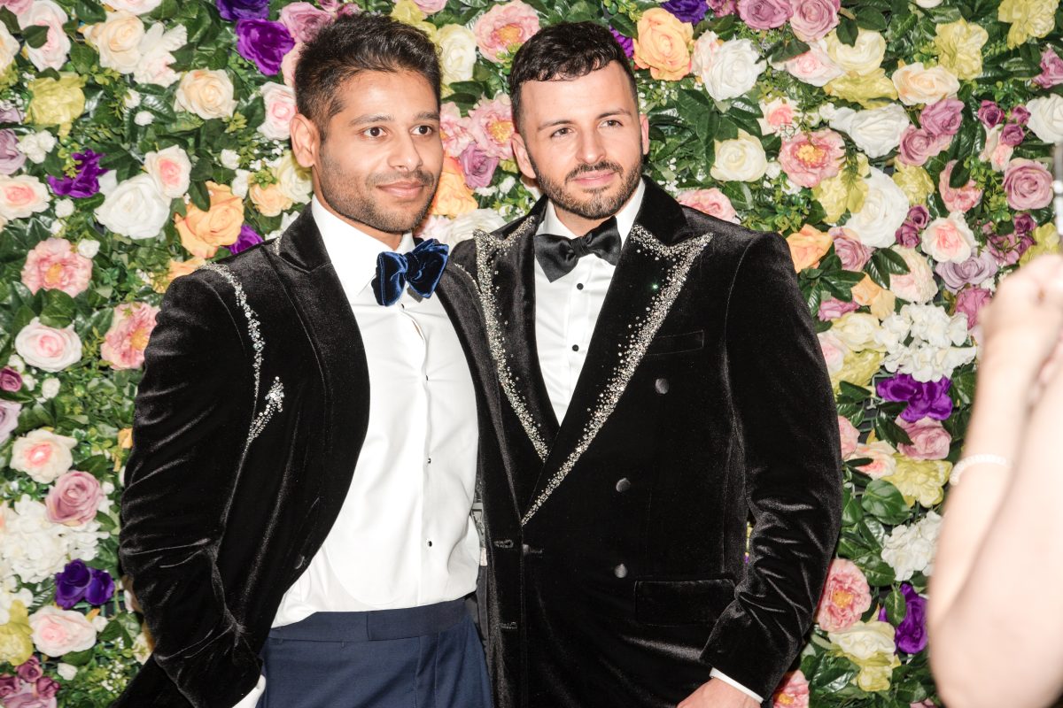 Two men dressed in velvet glam tuxedos