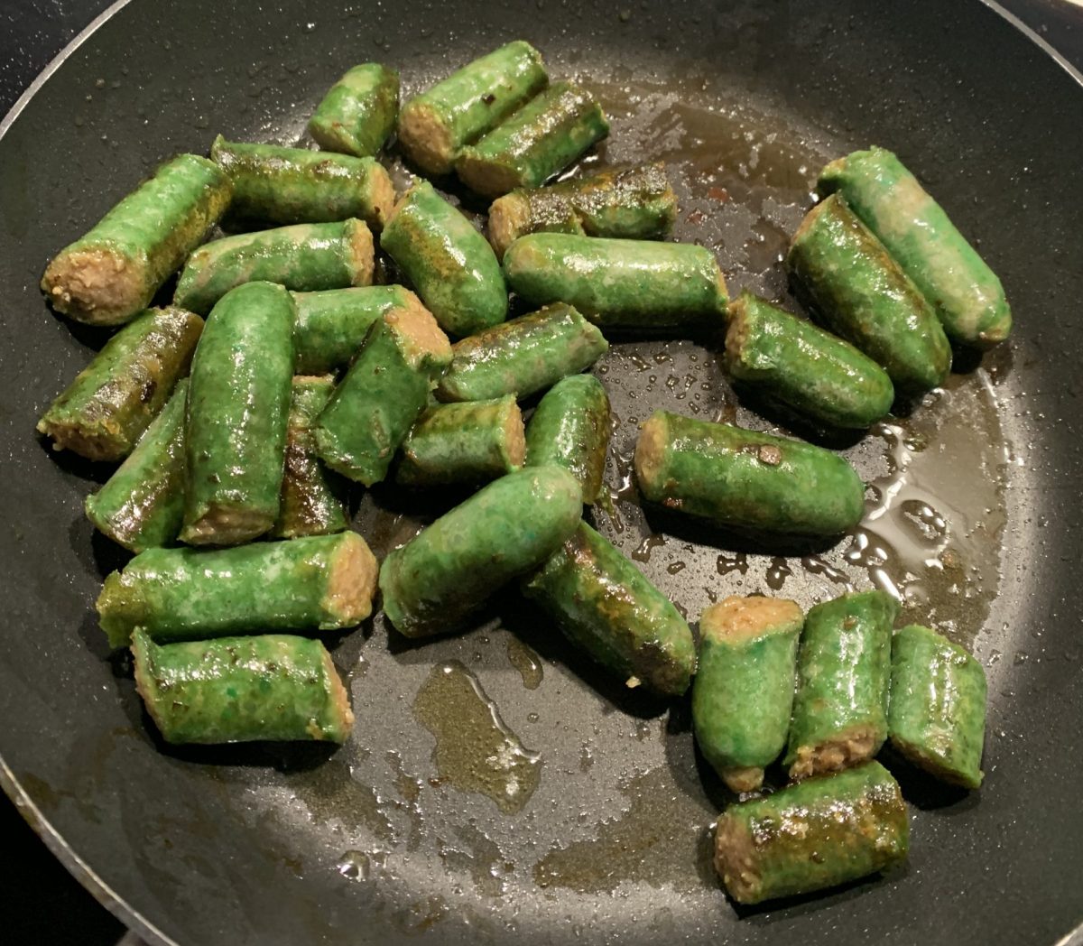 green sausages in a frypan