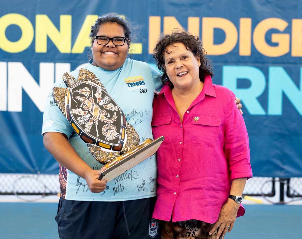 Two women standing with trophy