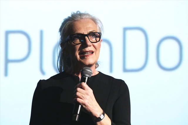 Anne Moore speaks into a microphone