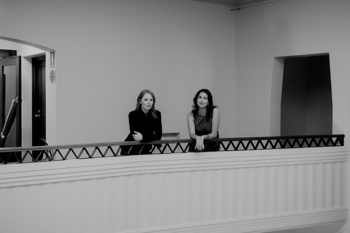 two women standing on a walkway