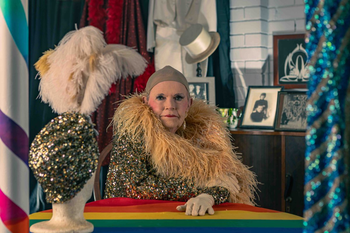 Photo of drag queen seated in a room