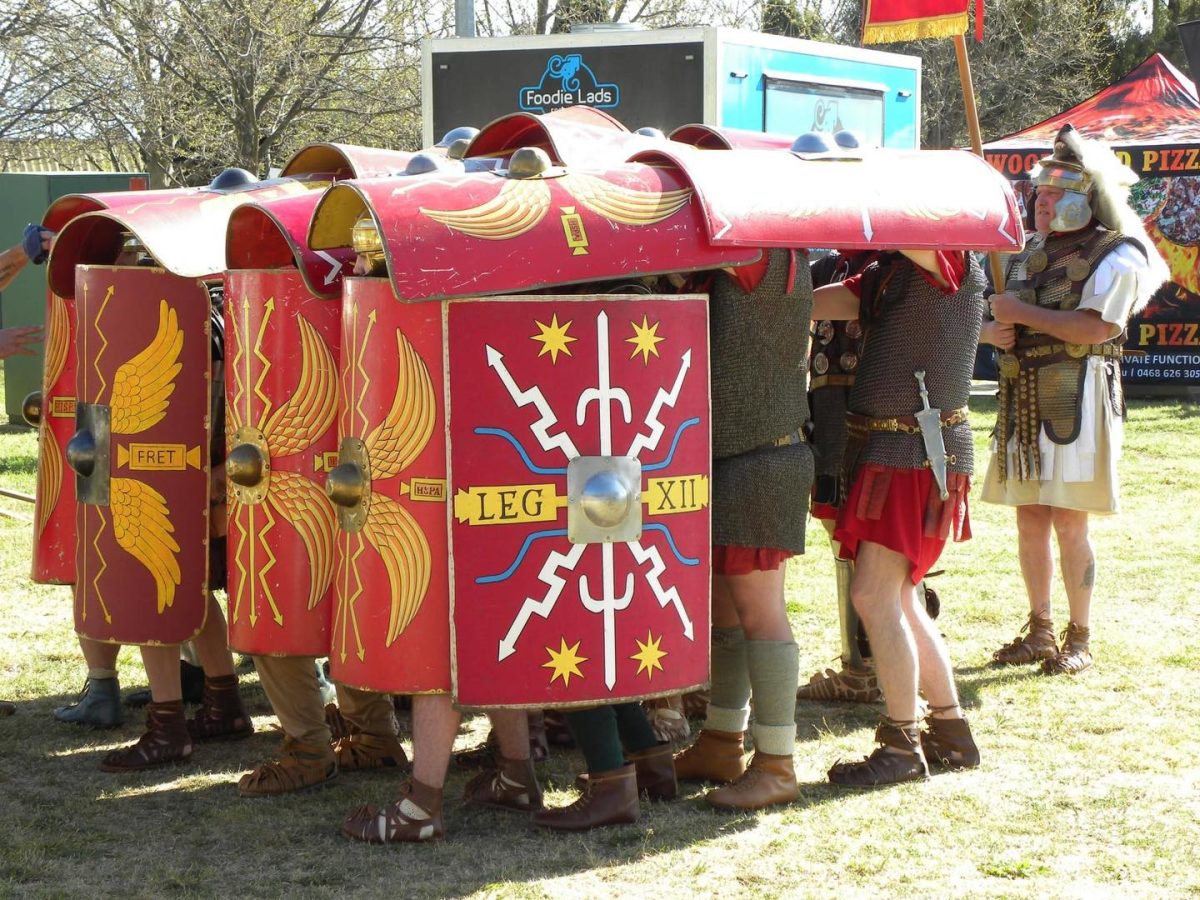 A reenactment of Roman soldiers sheltering underneath their shields