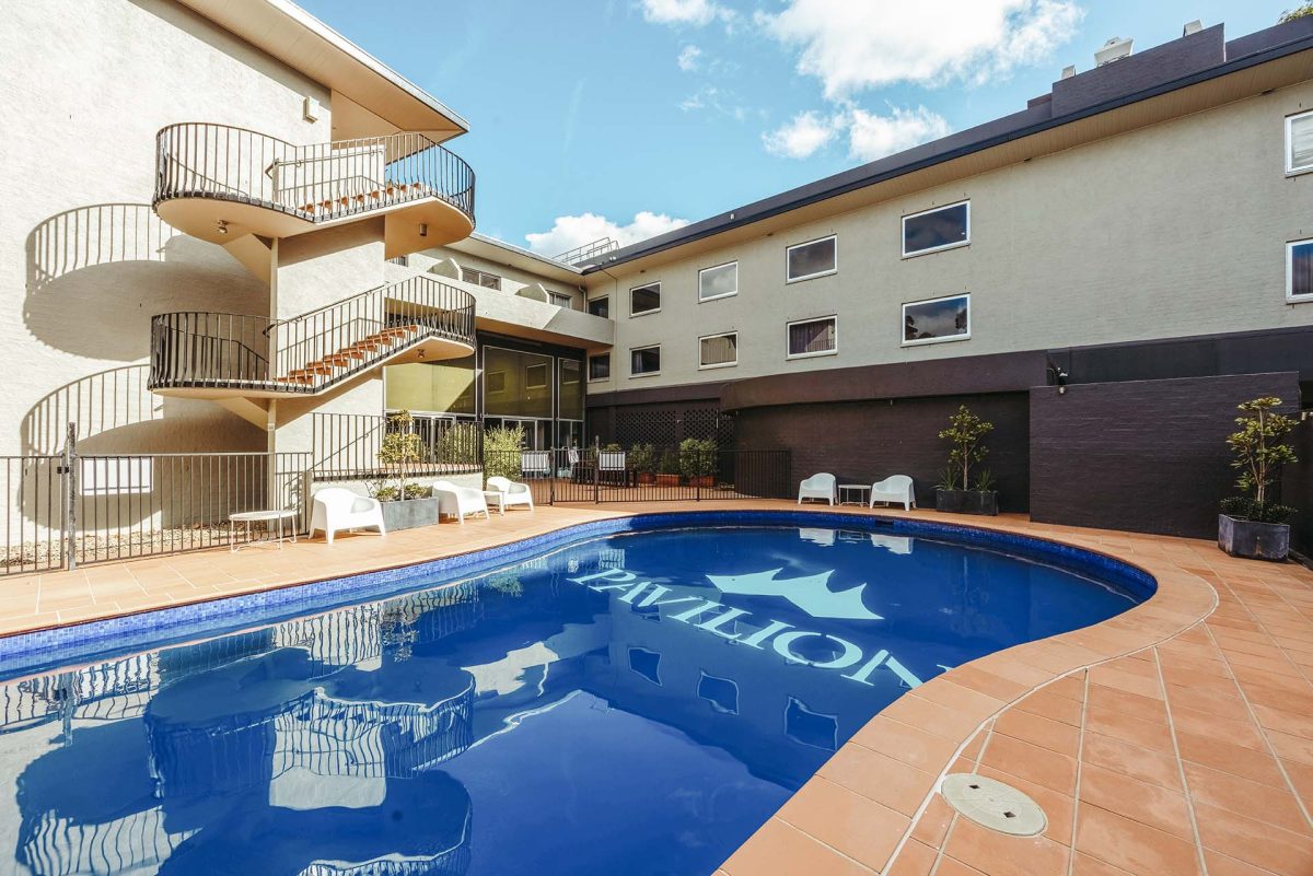 Pavilion on Northbourne pool area in front of apartment buildings