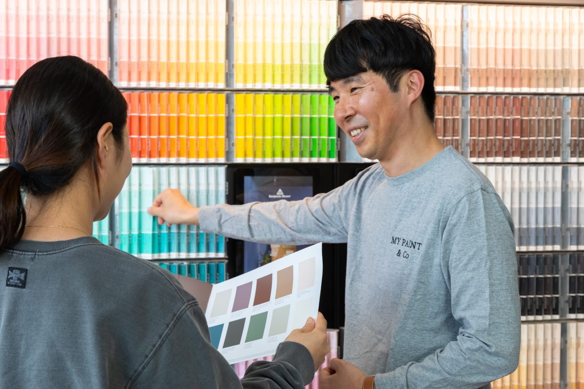 man and woman at paint colour chart