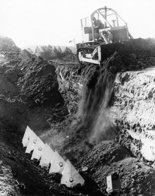 The Earthwork sculpture being buried in Commonwealth Park.