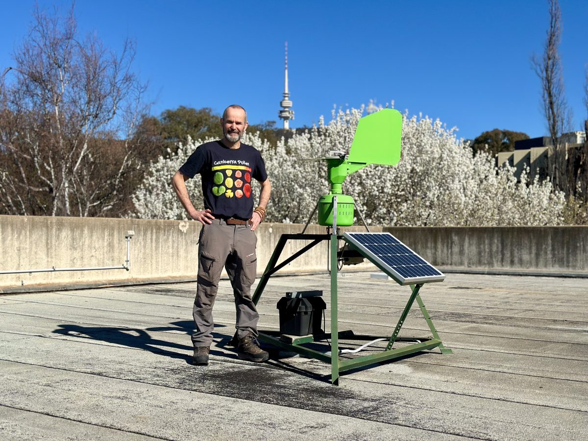 Man standing on rooftop with machine