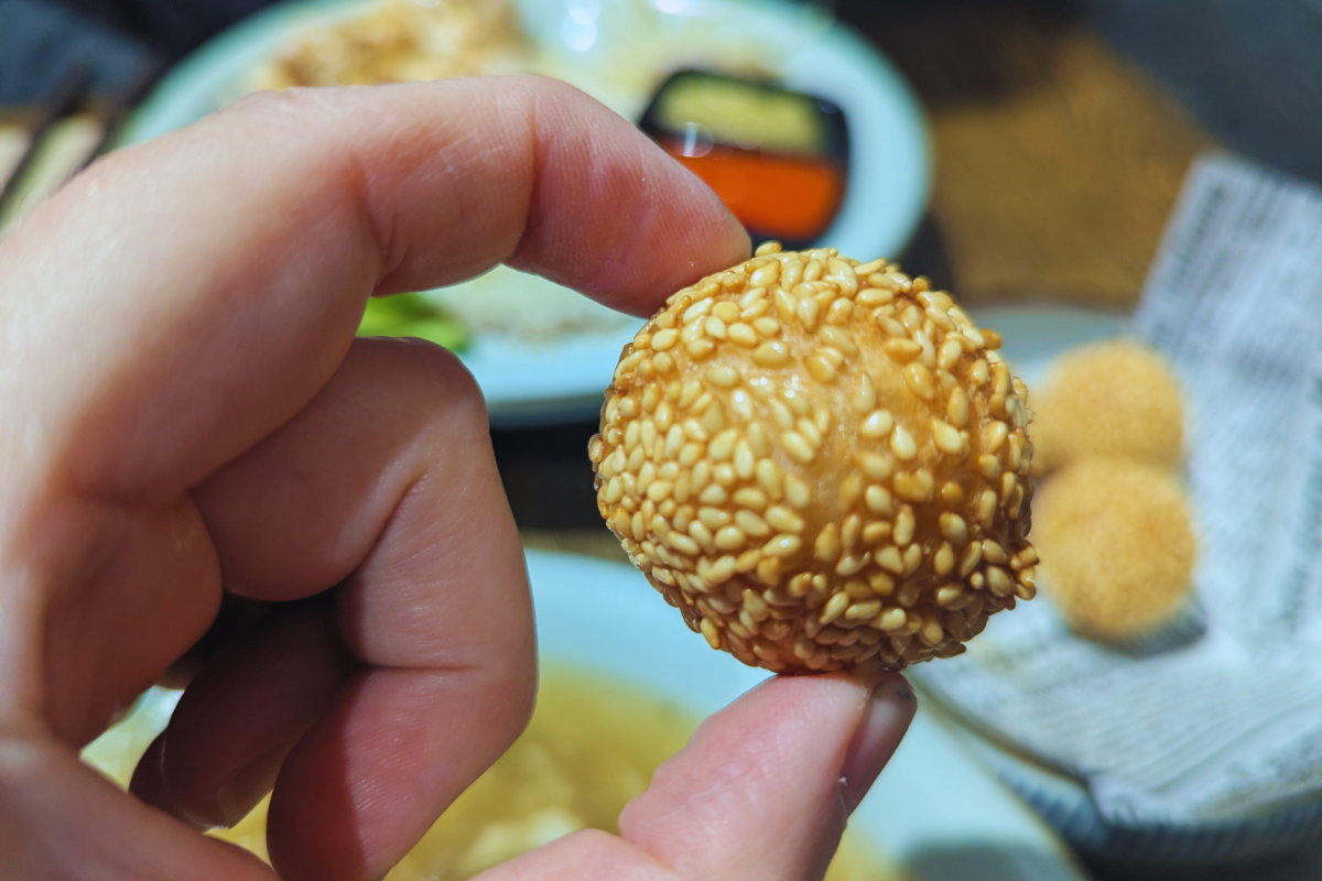Sesame ball being held.