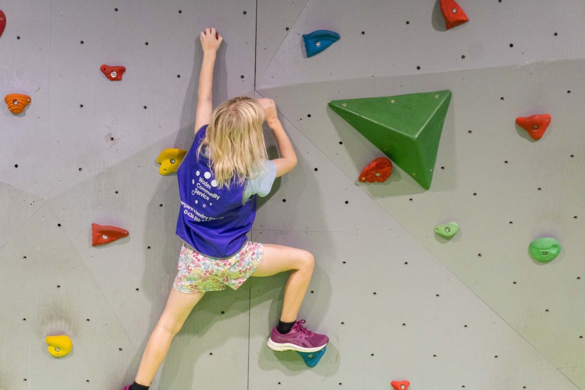 a child on a rock climbing wall