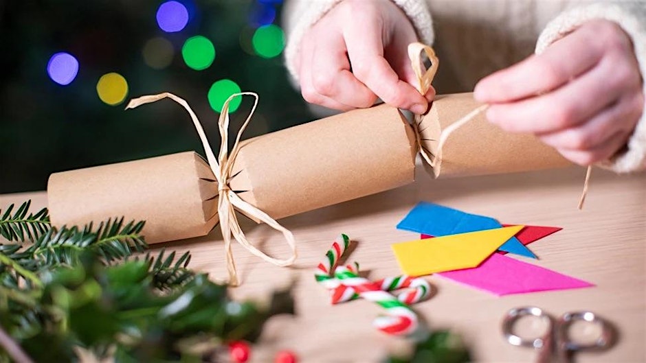 hands tying string around one end of a bonbon