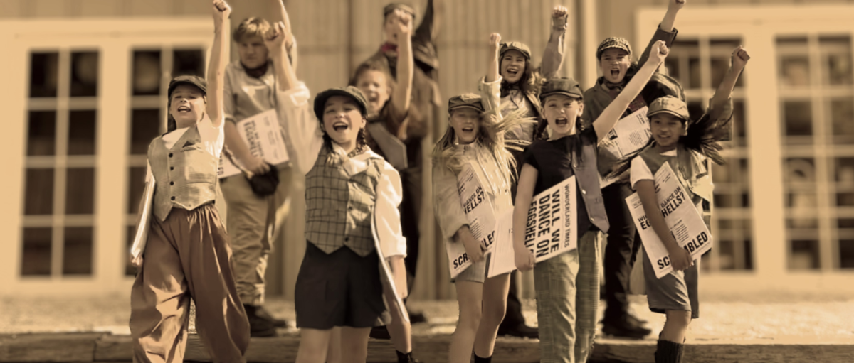 a sepia photo of a group of kids standing on steps of a building holding their fists in the air