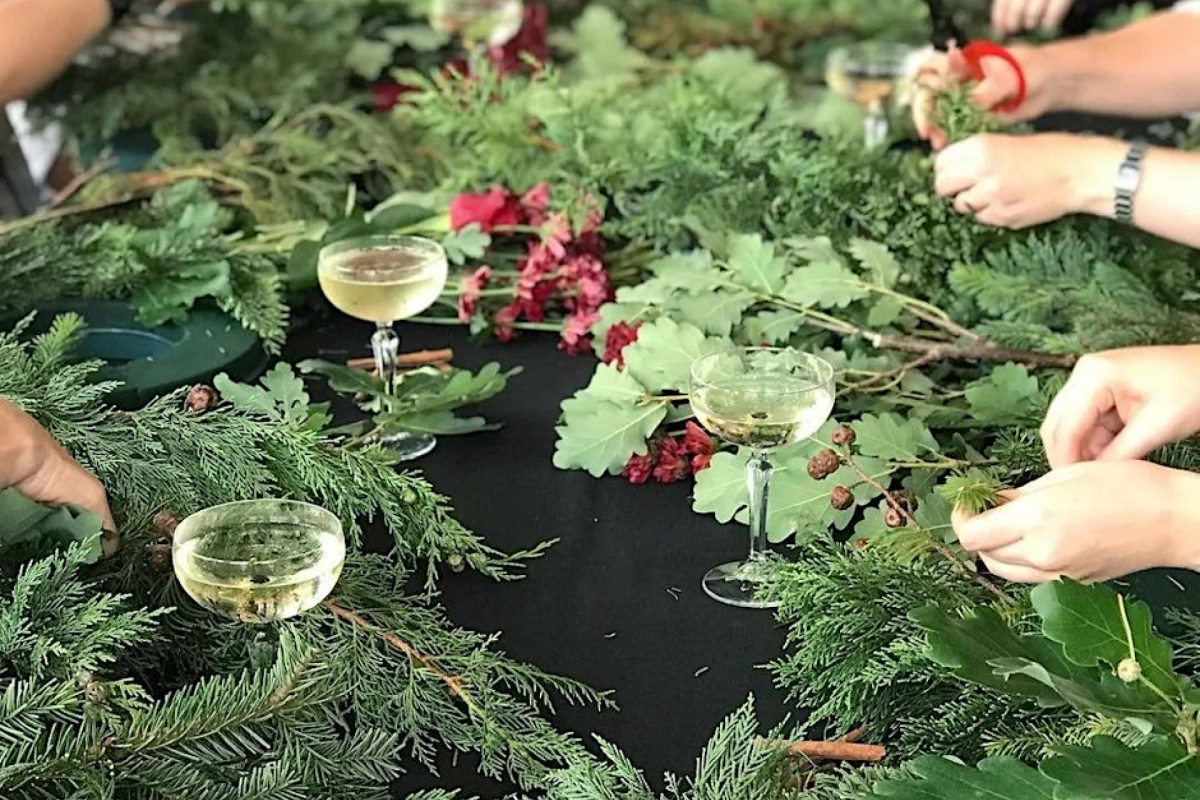 Hands holding leaves and sticks making garlands