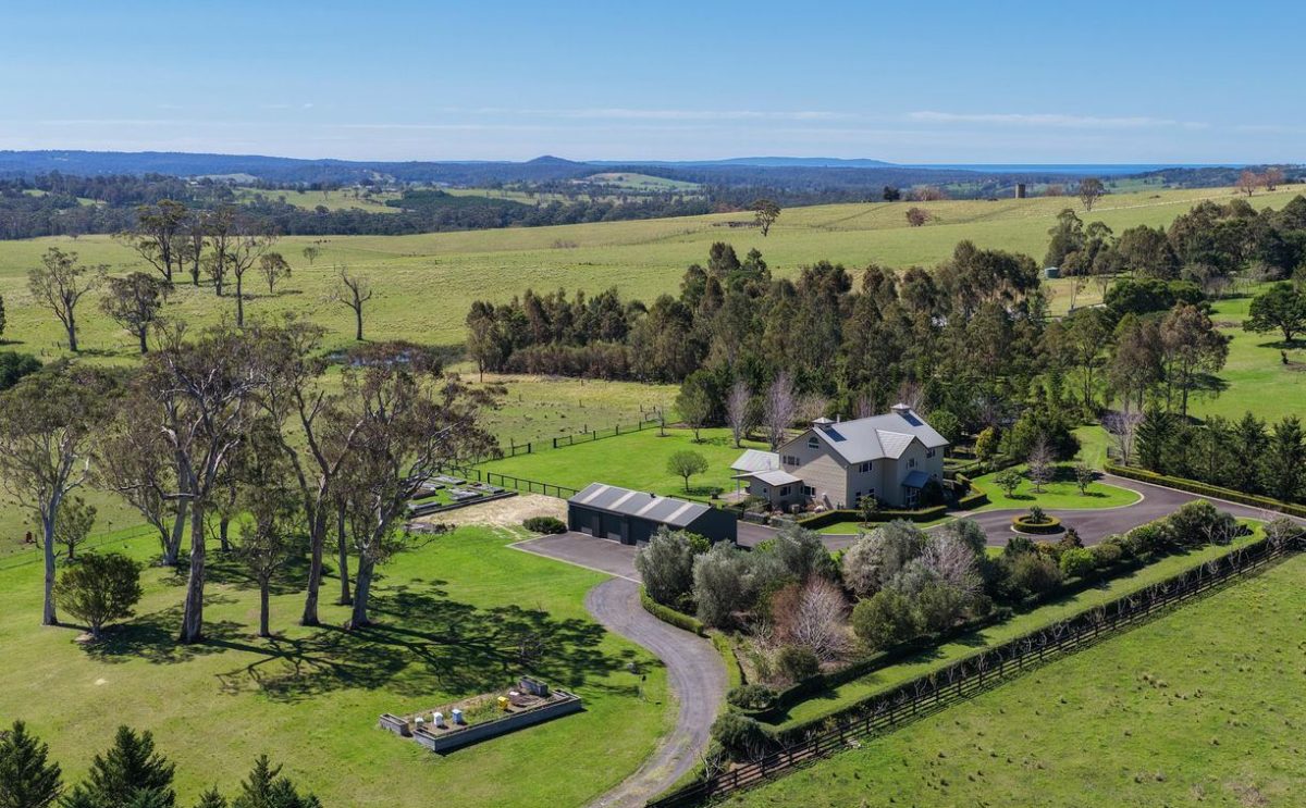 elegant two-storey country home with lush surrounds