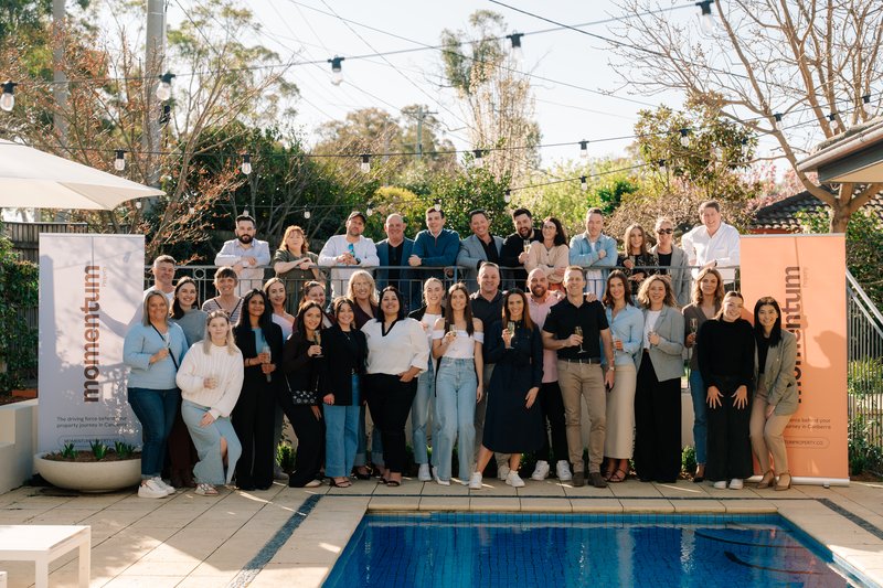 group of people standing by a pool