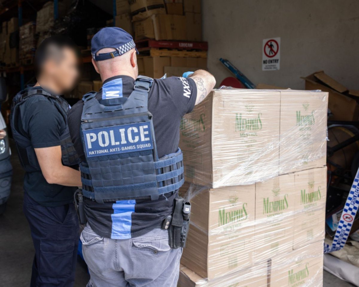 police officers with pallets of illicit tobacco