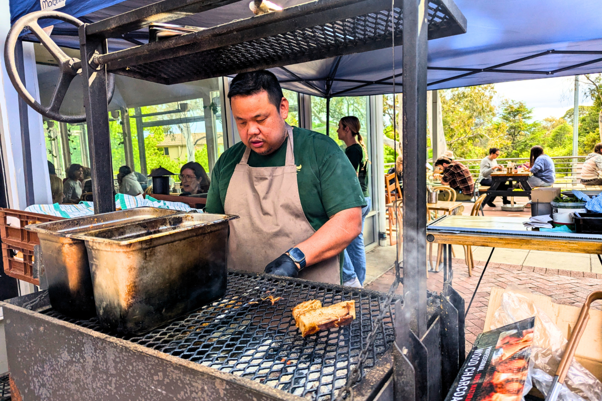 Man stands at grill.