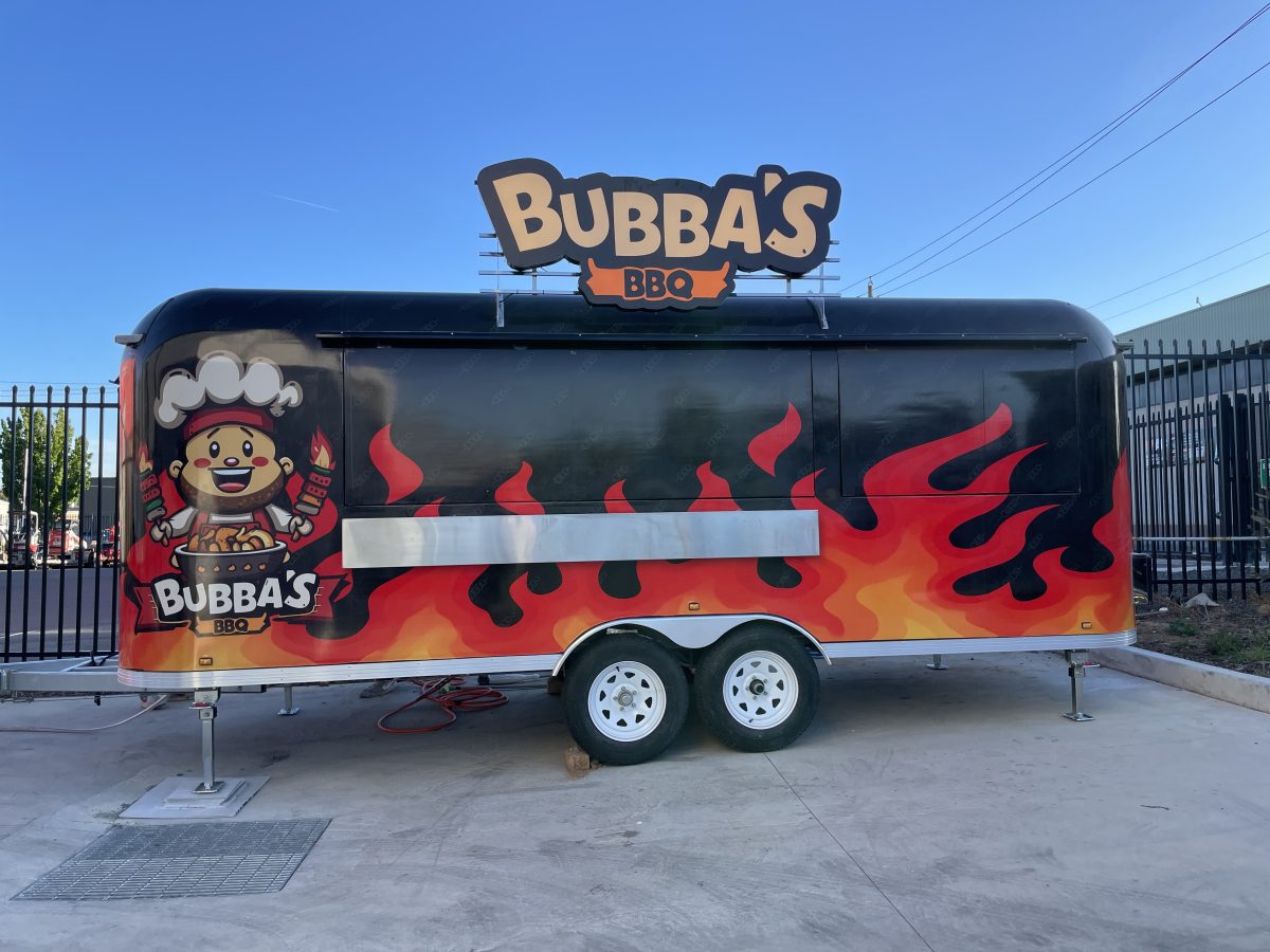 The Bubba's BBQ food truck, with cartoon chef, and red flames on black background.