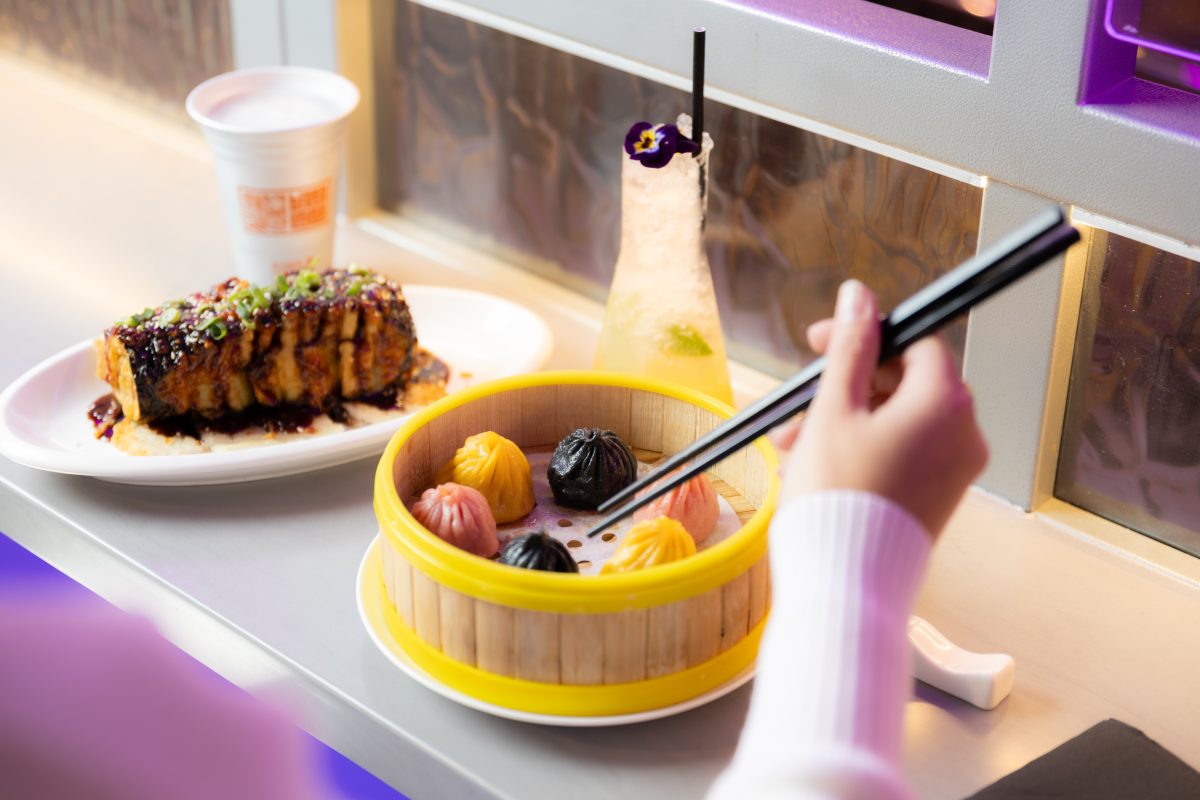A steamer with different coloured dumplings.