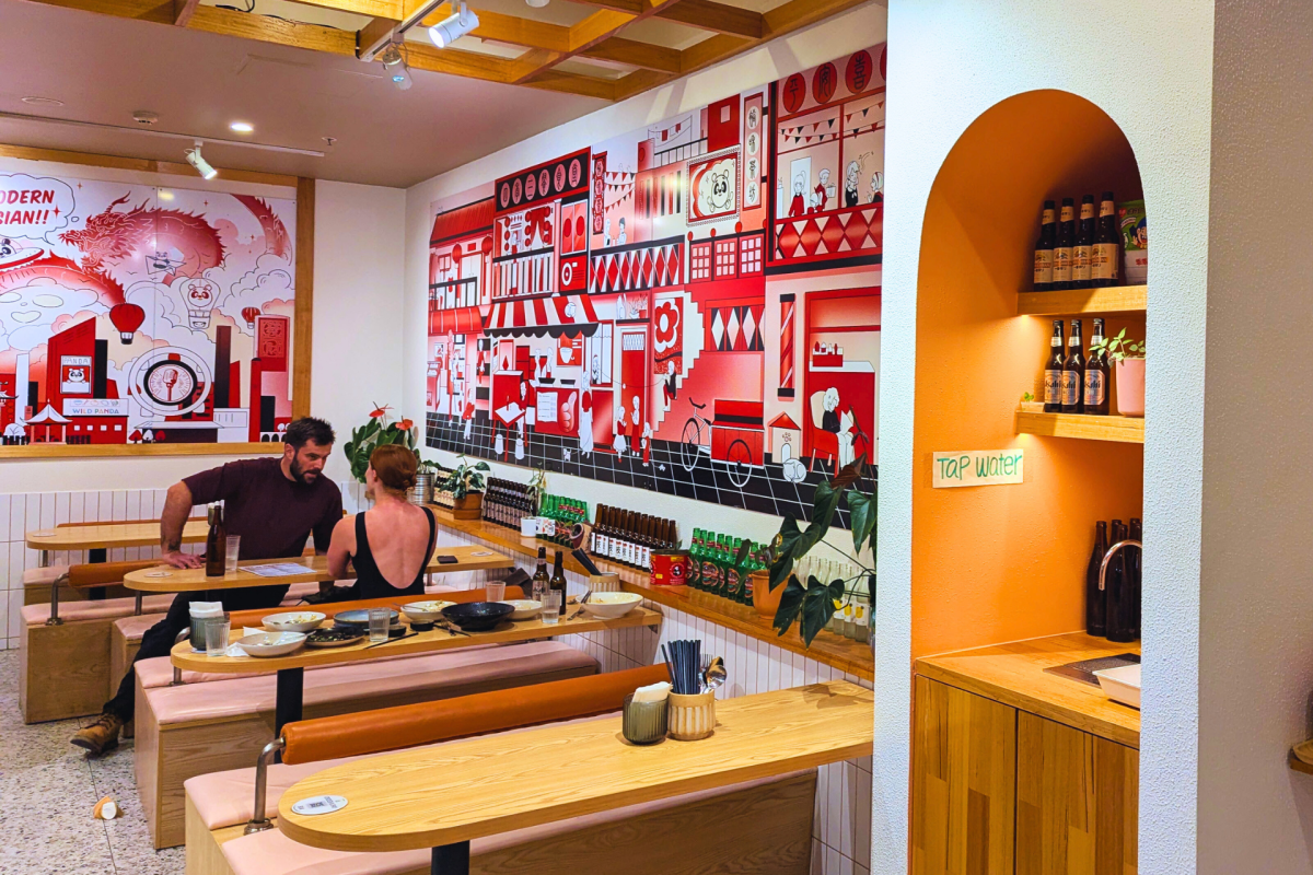 A restaurant with red and white murals on the walls.