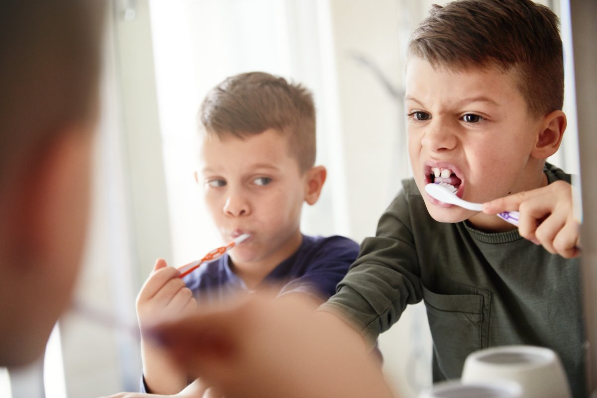 Little brothers brushing their teeth in the bathroom