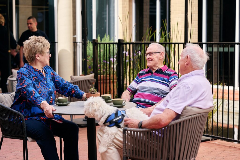 Di sitting and talking with residents