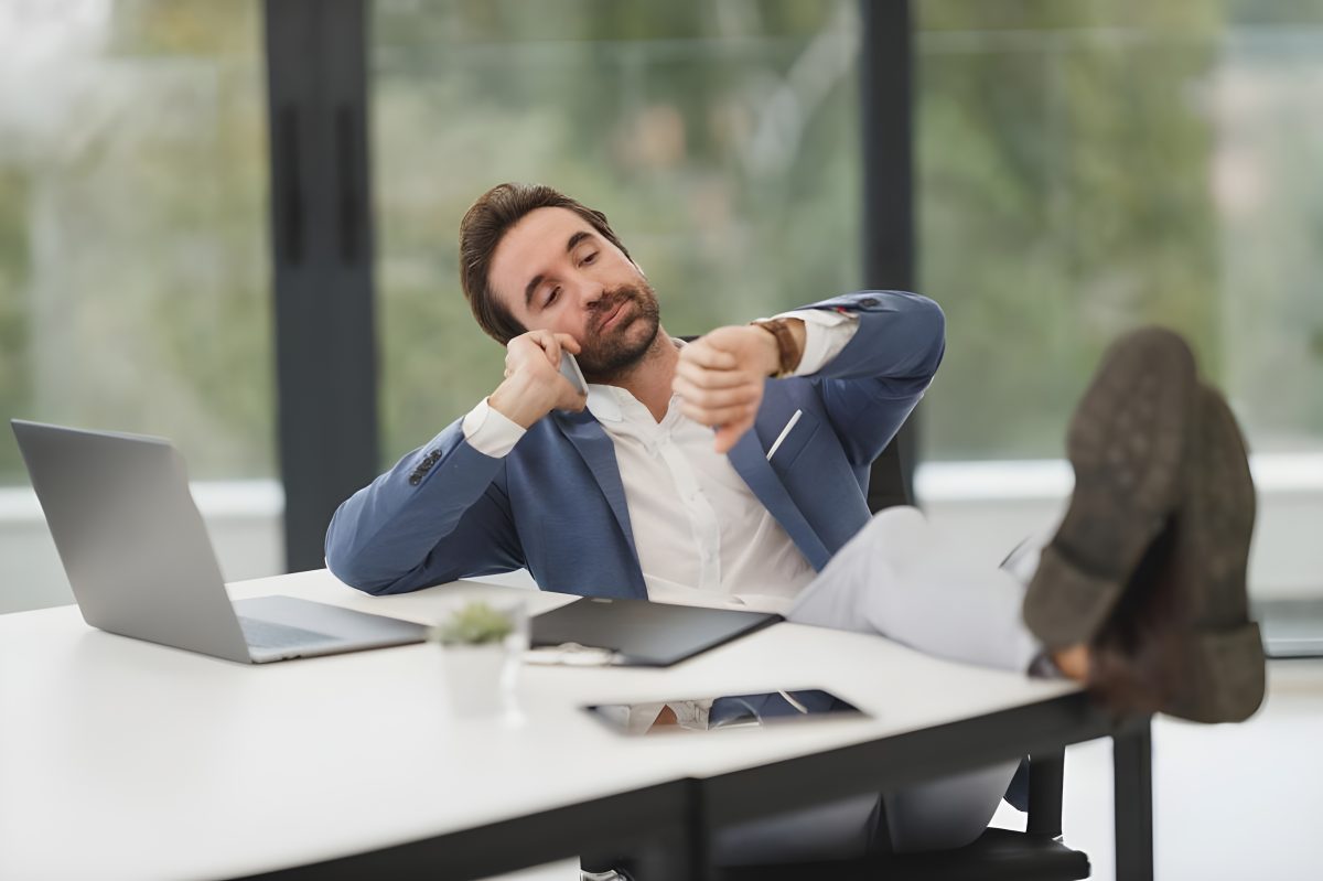 Guy with feet up at desk