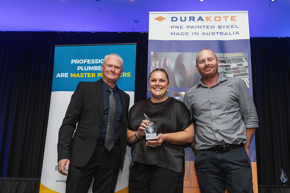Ben and Lynley Stapleton on stage accepting an award