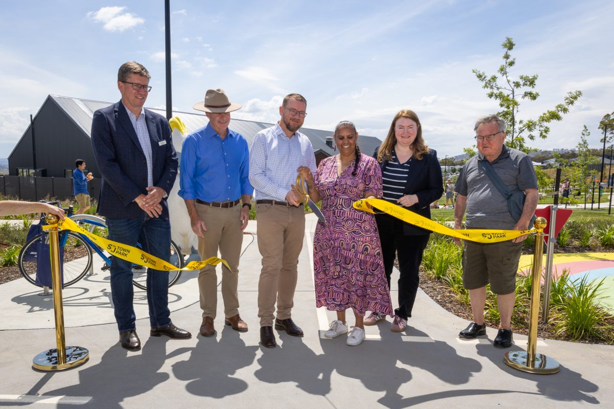 people in a line cutting a tape