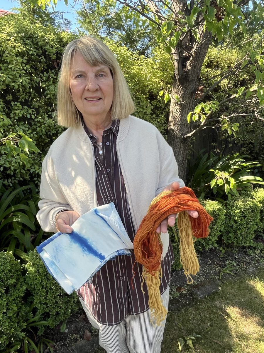 Woman holding naturally dyed fabrics