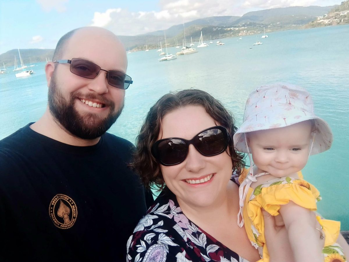 smiling family of three