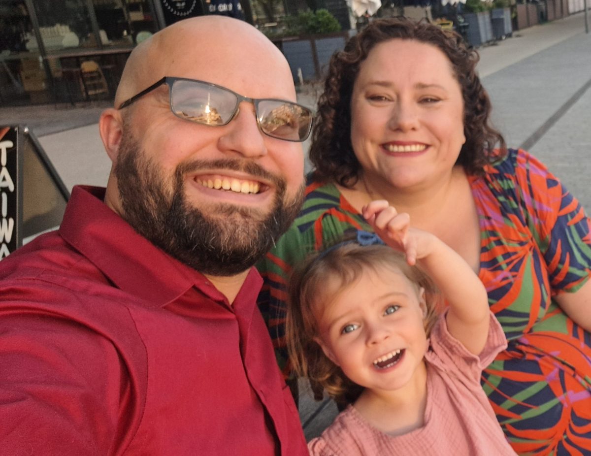 smiling family of three