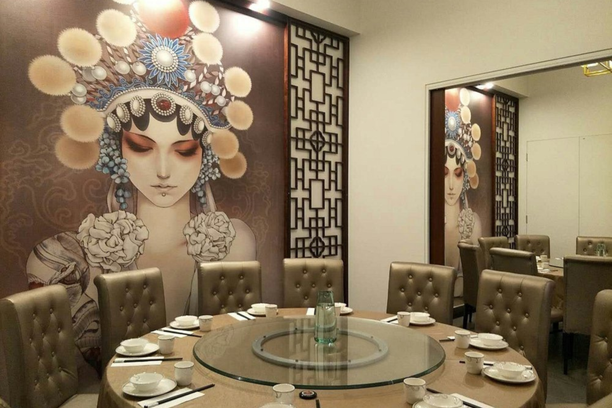 Dining room with mural on wall.