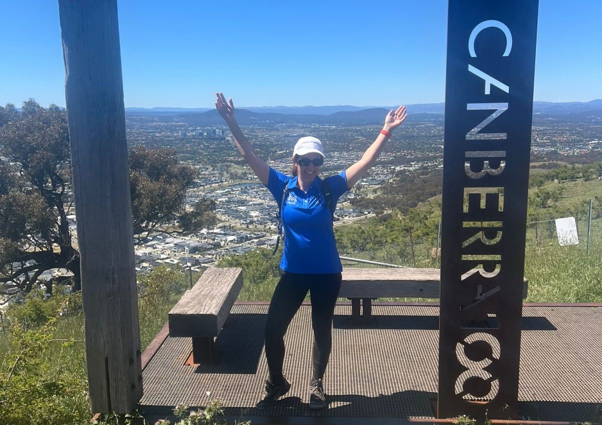 Jacquelyn Curtis throww hers arms up in the air at a Canberra lookout