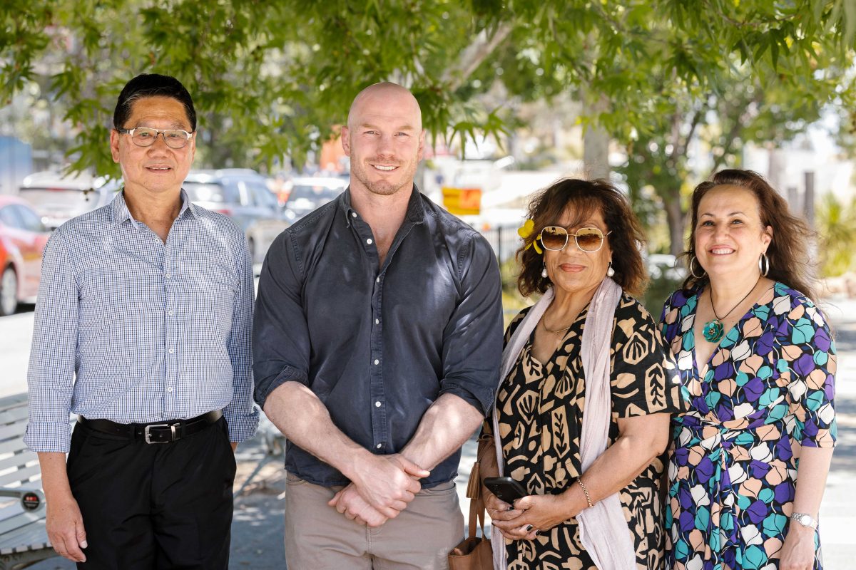 group of four people smiling