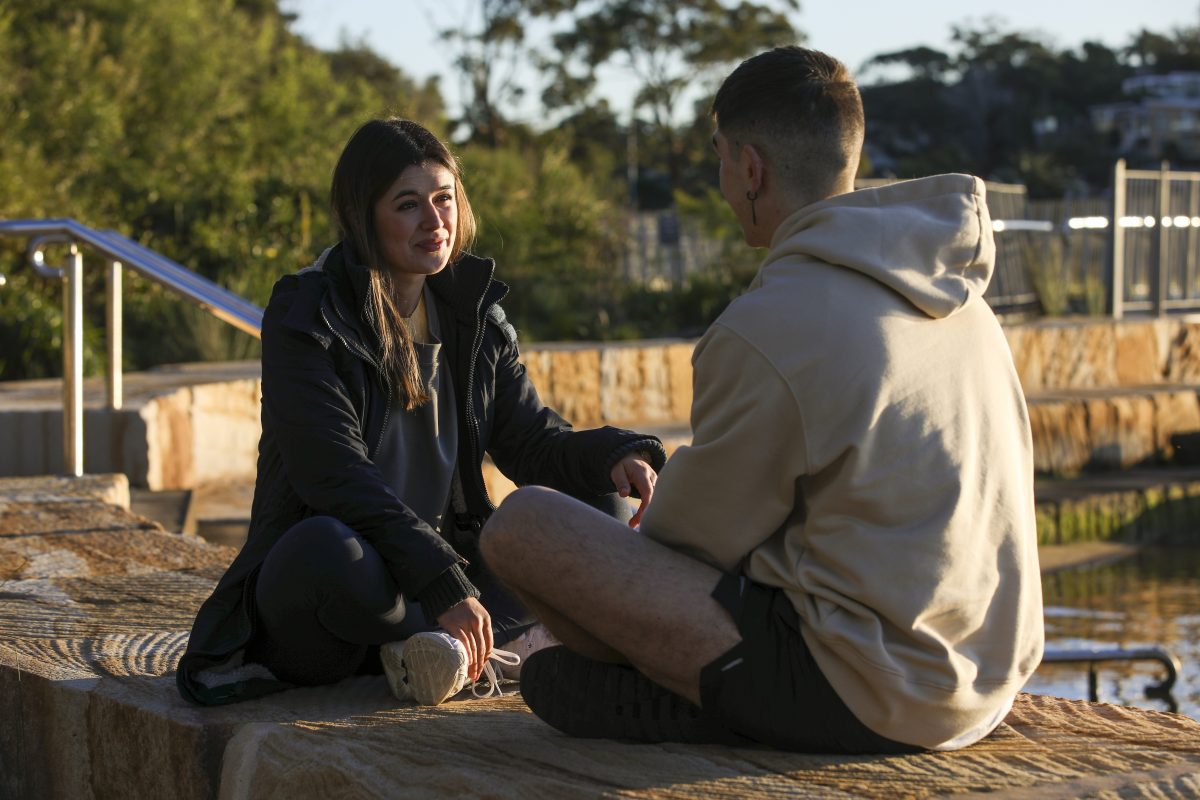 two people sitting and talking
