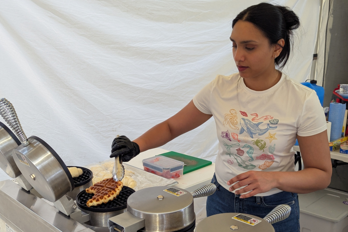 Woman turns croffle in waffle iron