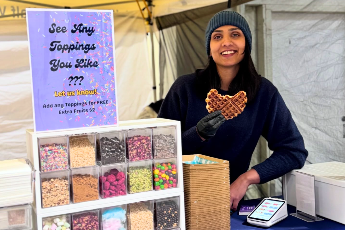 Woman holds Croffle and smiles at camera