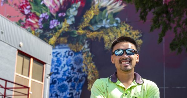 Local artist immortalises florals' fleeting beauty in Braddon's newest large-scale mural