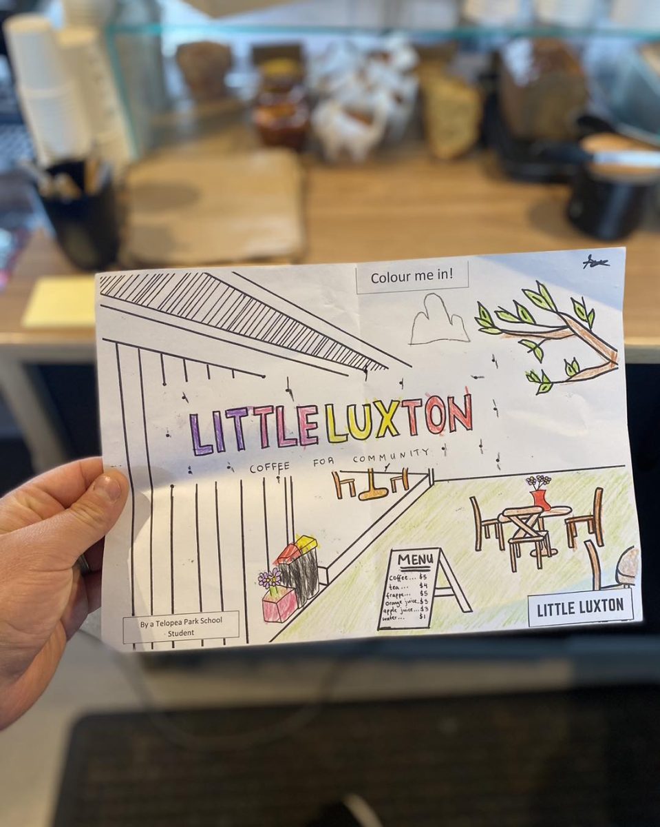 A partially coloured in sheet which is an illustration of Little Luxton. 