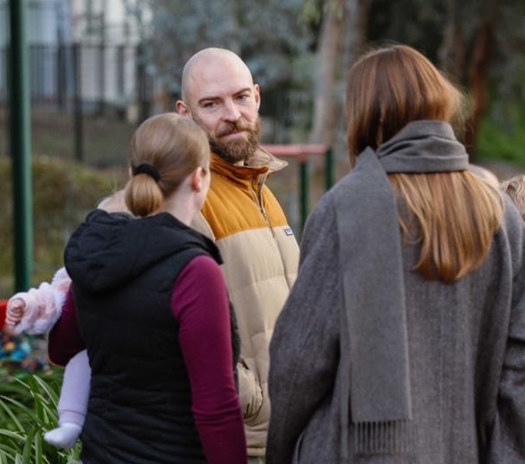 Thomas Emerson talking with community members