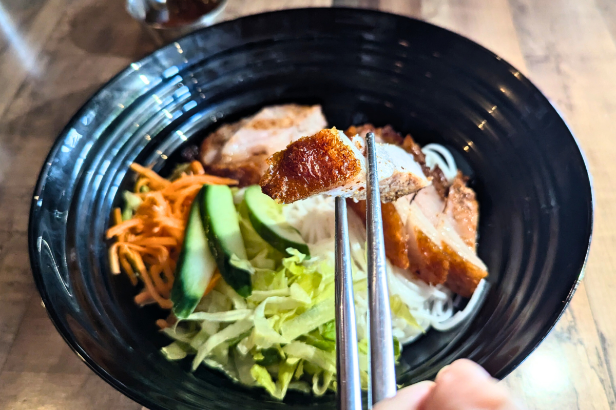 chopsticks holding pork