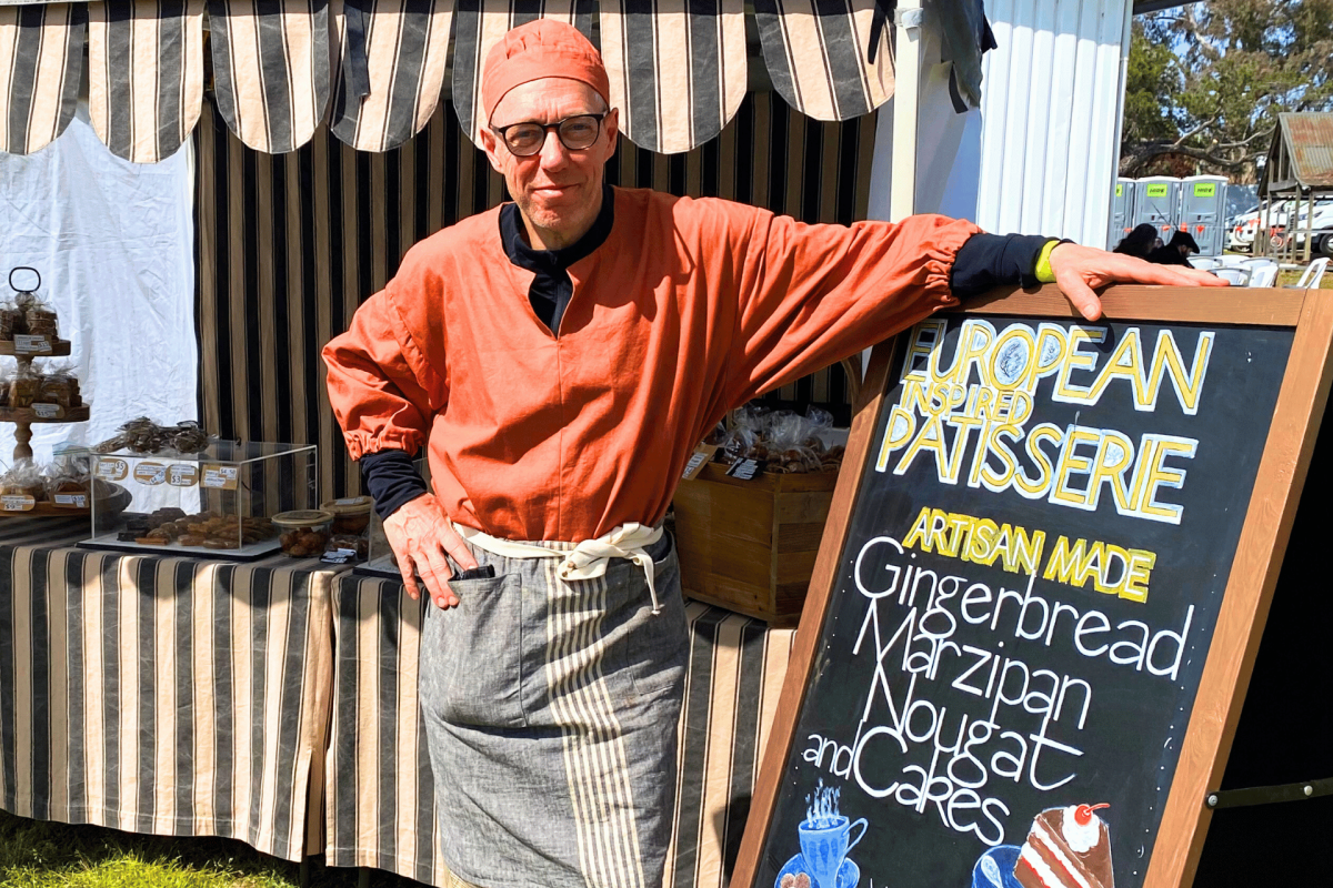 Chef standing at market stalls.
