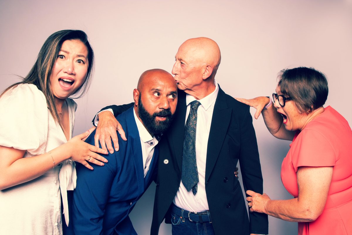 Four people standing in a line