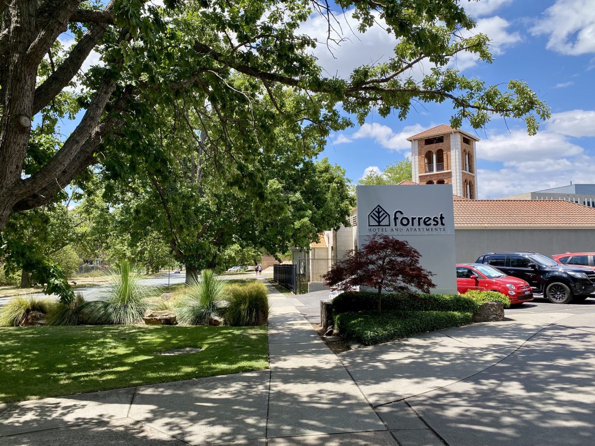 Forrest Apartments sign with the Italian Cultural Centre in the background