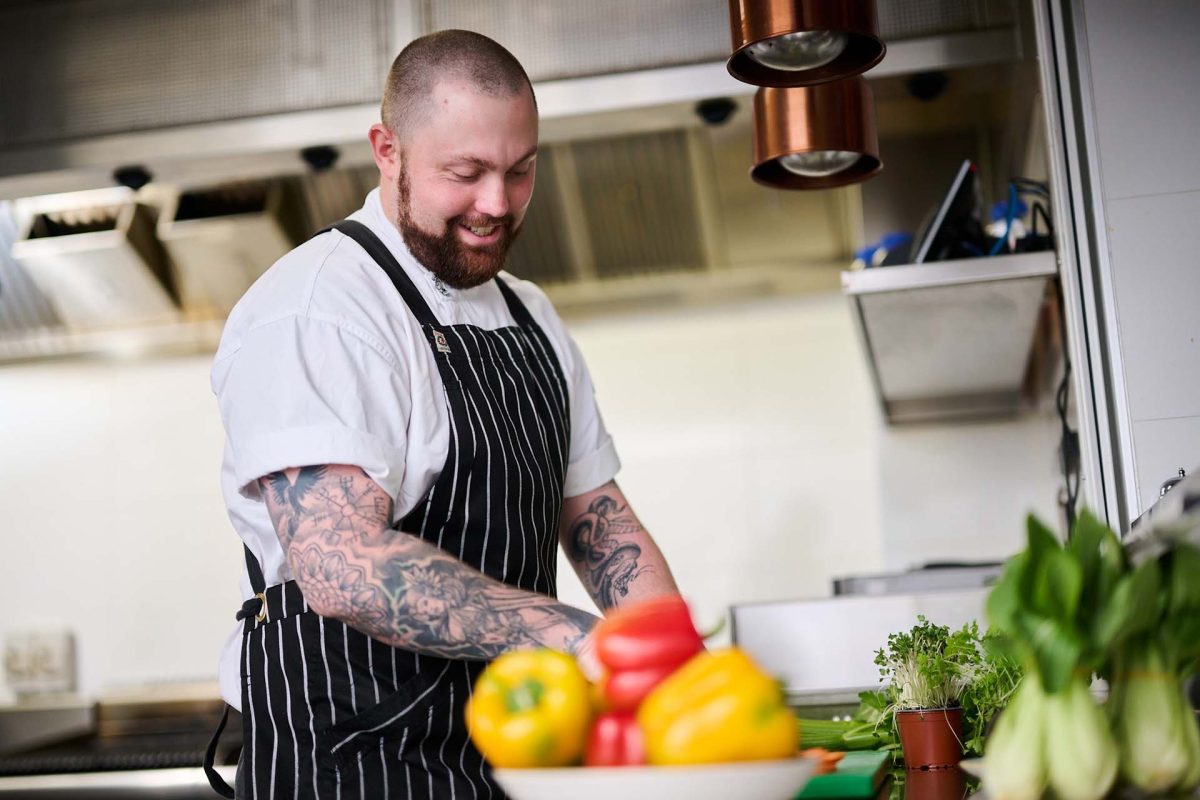 male chef cutting vegetables